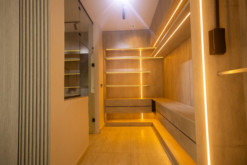 Brum Height 6: Walk-in wardrobe with open shelving and warm lighting